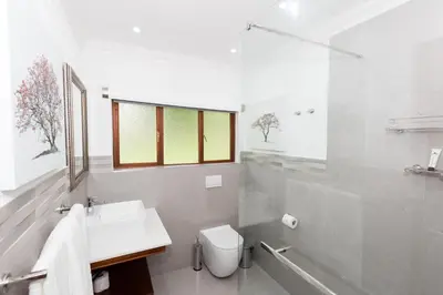 a white bathroom with a sink and a toilet at Kruger Park Lodge Unit No. 608B in Hazyview