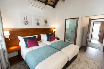 a bedroom with a large bed in a room at Kruger Park Lodge Unit No. 608B in Hazyview