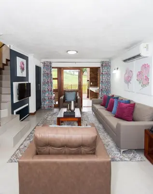 a living room with a couch and a table at Kruger Park Lodge Unit No. 608B in Hazyview
