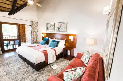 a bedroom with a bed and a couch at Kruger Park Lodge Unit No. 610A in Hazyview