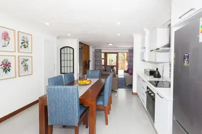 a kitchen and dining room with a table and chairs at Kruger Park Lodge Unit No. 610A in Hazyview