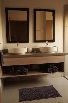 a bathroom with two sinks and two mirrors at Uchawi wa Afrika in Marloth Park