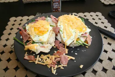 a plate of food with eggs and bacon and cheese at Oryx B&B Reserved Guests Only in Mokopane