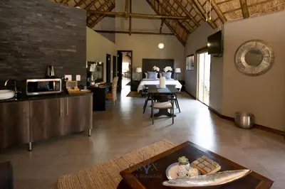a living room with a table and a dining room at Oryx B&B Reserved Guests Only in Mokopane