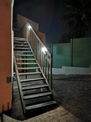 a set of stairs leading up to a building at night at King Protea Self Catering Accommodation in Erasmuskloof, Pretoria East in Pretoria