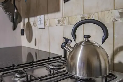 a tea kettle sitting on top of a stove at The South Post @ Kruger in Marloth Park