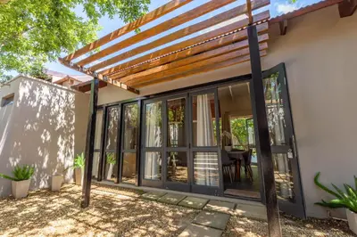 a pergola over a patio of a house at 109 Upwood in Dullstroom