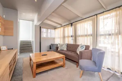 a living room with a couch and a table at 109 Upwood in Dullstroom
