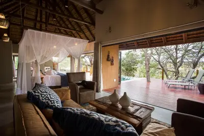 a living room with a couch and a table at Naledi Lodges in Balule Game Reserve