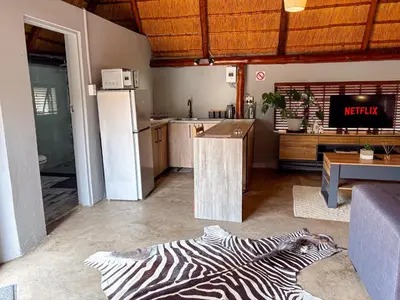 a living room with a zebra rug on the floor at @30 Zebra in Polokwane