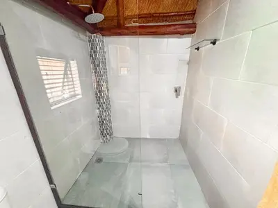 a bathroom with a shower with a toilet in it at @30 Zebra in Polokwane