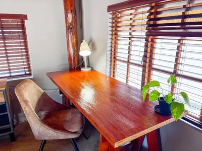 a wooden table with a potted plant and a lamp at @30 Zebra in Polokwane