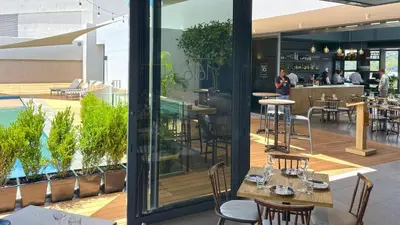 a restaurant with tables and chairs on a patio at Menlyn Maine Residences - Napoli with king sized bed in Pretoria