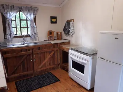 a kitchen with a white stove and a sink at Declan House in Louis Trichardt