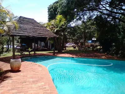 a swimming pool in a yard with a pavilion at Declan House in Louis Trichardt