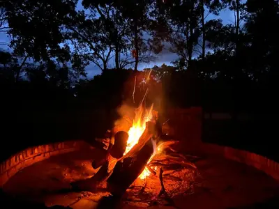 a fire burns in a fire pit at night at Vilagama Game Lodge in Naboomspruit
