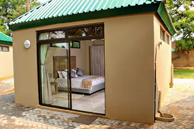 a small house with a bed inside of it at Zoe Bush Lodge in Pretoria