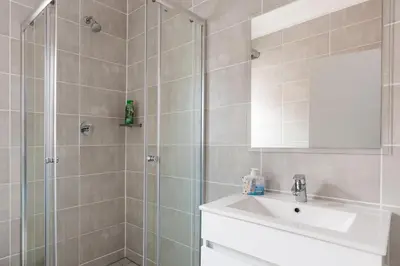 a bathroom with a shower and a sink and a mirror at Alimama Spaces: The Manson's Blyde in Pretoria