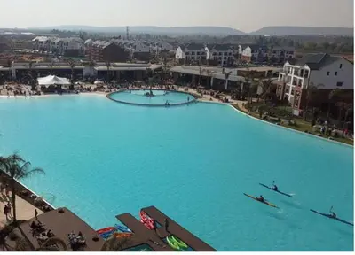 a large pool of blue water with two boats in it at Alimama Spaces: The Manson's Blyde in Pretoria