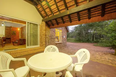 a white table and chairs on a patio at NJIRI - Your part of Africa in Marloth Park