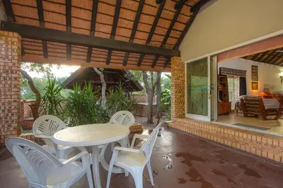 a patio with a table and chairs on a house at NJIRI - Your part of Africa in Marloth Park