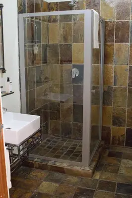 a bathroom with a shower and a sink at The Wild Olive Guest House in Centurion