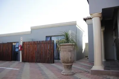 a potted plant in a planter in front of a building at Thavhani Guest House in Thohoyandou