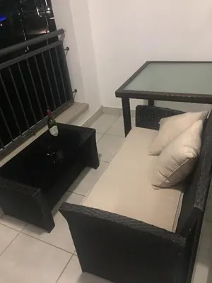 a black chair with a table and a bottle of wine at The Blyde - Beachfront in Pretoria