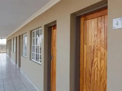a hallway with wooden doors in a building at Mon Reve in Lephalale