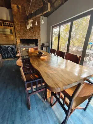 a large wooden table in a room with chairs at Elandsfontein 21, Mabalingwe in Mabula
