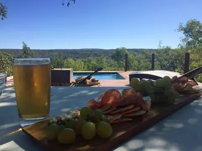 a table with a plate of food and a glass of beer at Elandsfontein 21, Mabalingwe in Mabula