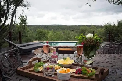 a wooden table with food and drinks on a patio at Elandsfontein 21, Mabalingwe in Mabula