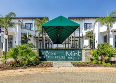 a sign in front of a hotel with a building at The Blyde Riverwalk Estate in Pretoria