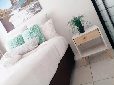a bedroom with a bed and a table with a plant on it at The Blyde Riverwalk Estate in Pretoria