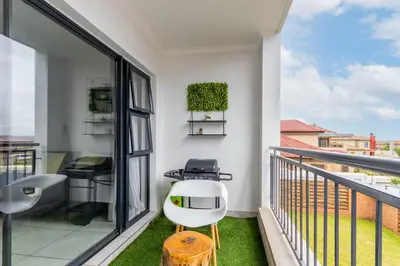 a balcony with a white chair and a table at The Blyde Riverwalk Estate in Pretoria