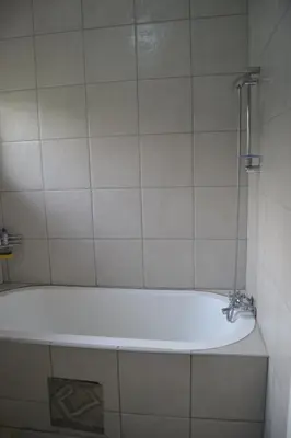 a bath tub with a faucet in a bathroom at Green Grove Villa in Centurion