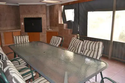 a conference room with a glass table and chairs at Green Grove Villa in Centurion