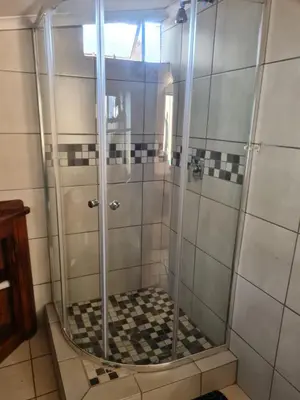 a shower with a glass door in a bathroom at Home Sweet Home in Polokwane