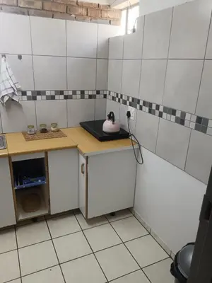a small kitchen with a counter and a sink at Home Sweet Home in Polokwane