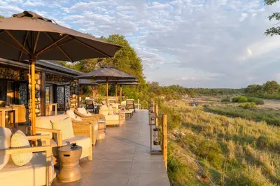 a restaurant with tables and chairs and an umbrella at Last Word Kitara in Klaserie Private Nature Reserve