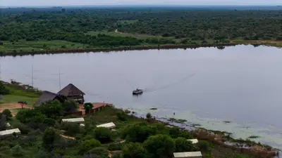 an aerial view of a large lake with a boat in it at Little Mongena Tented Camp in Klipdrift