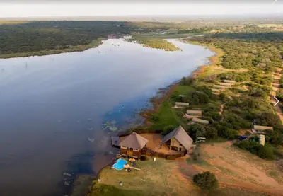 an aerial view of a house next to a river at Little Mongena Tented Camp in Klipdrift