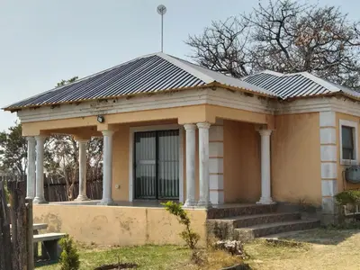 an old house with a solar roof at Hornbills lodge bnb in Mbabat