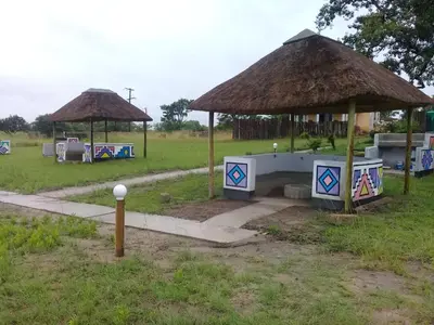 a field with two pavilions and a pavilion at Hornbills lodge bnb in Mbabat