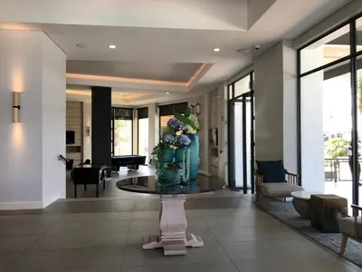 a lobby with a table with a vase of flowers on it at The Blyde Riverwalk Estate in Pretoria