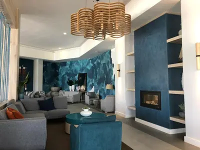 a living room with a blue accent wall at The Blyde Riverwalk Estate in Pretoria