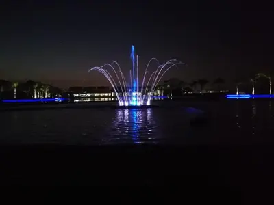 a fountain in the middle of the water at night at The Blyde Riverwalk Estate in Pretoria