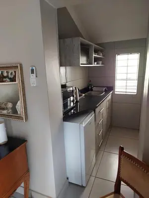 a small kitchen with a sink and a microwave at Big Tree Guesthouse Brits in Brits