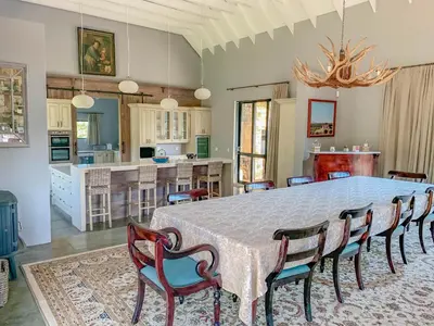a dining room and kitchen with a table and chairs at 93 Hillcrest in Dullstroom