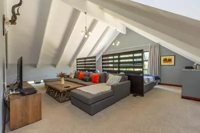 a living room with a couch and a television at 93 Hillcrest in Dullstroom